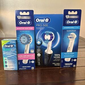 Oral B Pro 500 rechargeable toothbrush with extra heads and floss NIB